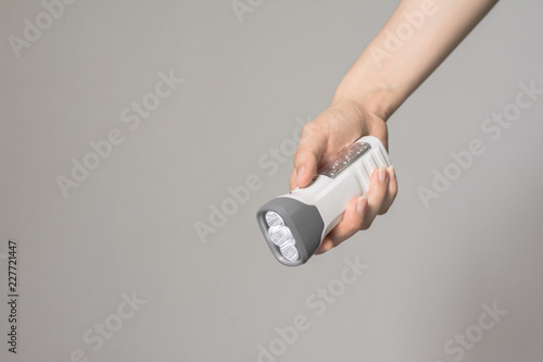 Close up woman hand holding modern flashlight ,LED flashlight.