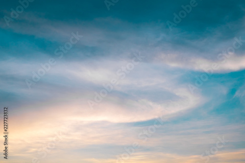 Sunset sky with curve cloud in blue and yellow color