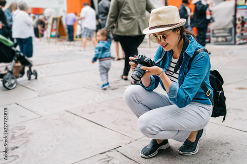 an elegant female traveler crouch on the street