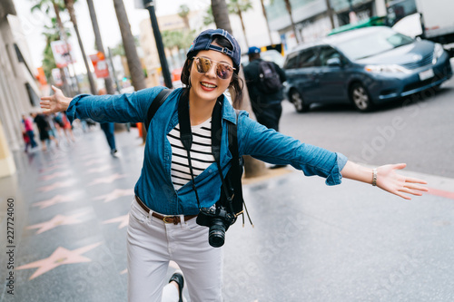 tourist joyfully standing on Hollywood Boulevard