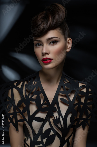 beautiful young woman with fancy hairdo and red lips photo