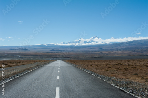 Road leading toward snow mountain peak in the distance