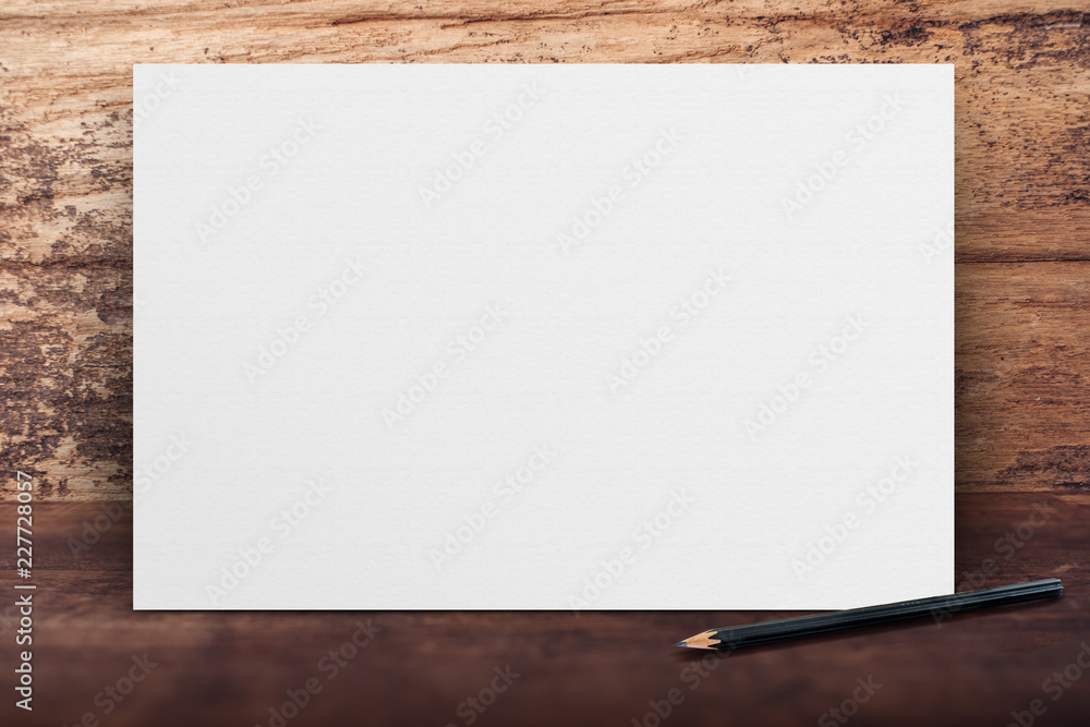 Blank banner white paper poster leaning at grunge wood wall on wooden floor in perspective room,Business mock up presentation.Template display of design or content.