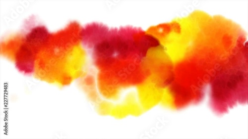 Beautiful red, yellow and orange spots appear on a white background. Bright paints spreads on paper forming a blots.