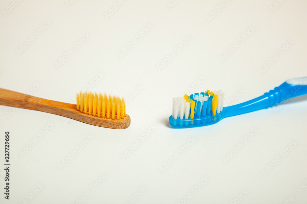 Toothbrushes on gray background. Concept toothbrush selection, bamboo eco-friendly and plastic Toothbrushes on gray background. Concept toothbrush selection, bamboo eco-friendly and plastic