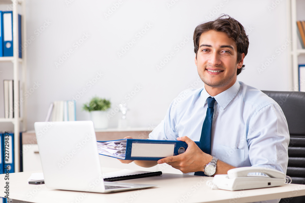 Young handsome businessman working in office Young handsome businessman working in office