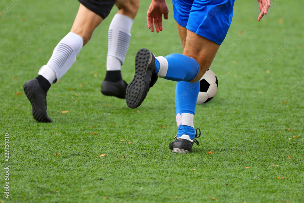 Boys playing a football match and empty space for text Boys playing a football match and empty space for text