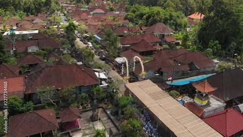 4K aerial flying video of balinese houses during the big celebration. Bali ceremony in village, Ubud. Roofs of balinese houses.