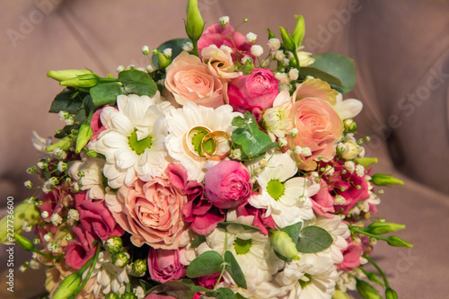 Wedding Rings with beautiful natural flowers bouquet