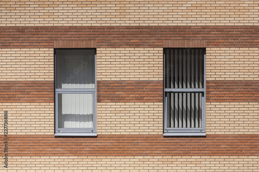 The wall of a brick building and a window. The wall of a brick building and a window.