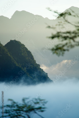 Sunrise in mountains of Pu Luong national park, Vietnam with misty morning light and clouds