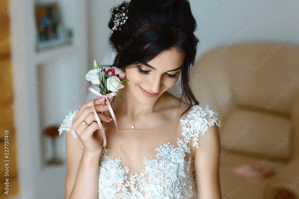 gorgeous bride with boutonniere portrait. bridal boudoir on wedding day. beautiful woman getting ready for wedding, holding flowers. sensual moment gorgeous bride with boutonniere portrait. bridal boudoir on wedding day. beautiful woman getting ready for wedding, holding flowers. sensual moment