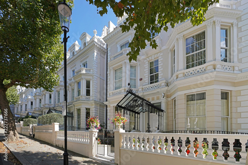 London/UK - August 2018: A premier street in Kensington, Holland Park. A terrace of multimillion pound luxurious villas, celebrity homes as well as homes of multimillionaires and billionaires.  photo