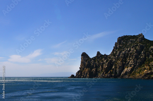 beautiful natural landscape photo of sea and mountains with bright blue sky