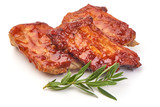 Delicious spicy marinated ribs in a bbq or tomato sauce with herbs, isolated on a white background. Close-up.