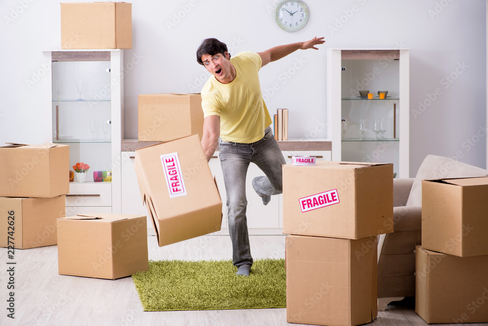Man moving house and relocating with fragile items Man moving house and relocating with fragile items