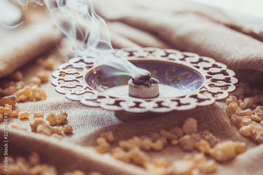 Frankincense burning on a hot coal. Frankincense is an aromatic resin, used  for religious rites, incense and perfumes, incense smoke (color toned  image) Stock Photo | Adobe Stock