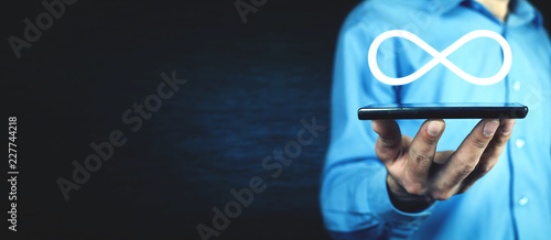 Man holding Infinity symbol. Business concept photo