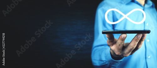 Bild auf Leinwand Man holding Infinity symbol. Business concept
