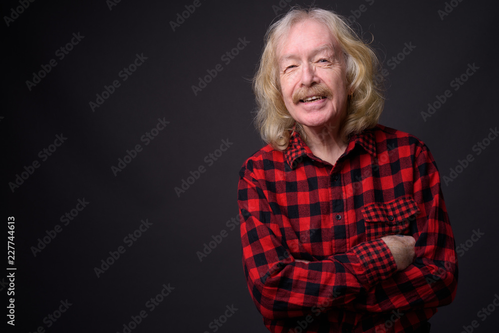 Senior man with mustache against gray background Senior man with mustache against gray background