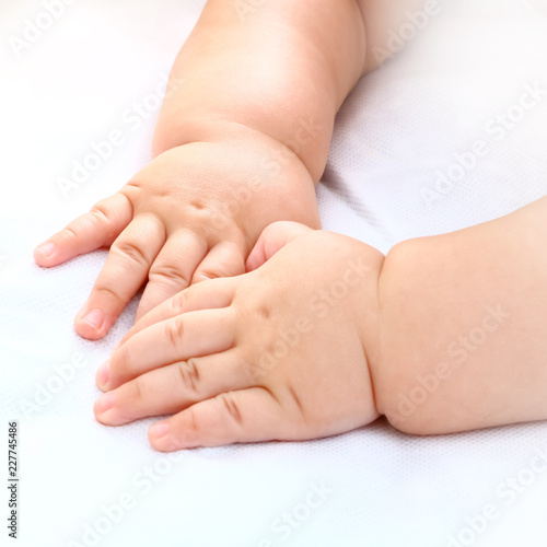 baby boy's hand on white background