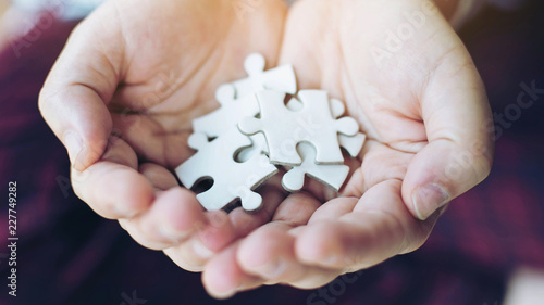 фотографія close up hand people putting a jigsaw puzzle on hand , business  Strategy soluti
