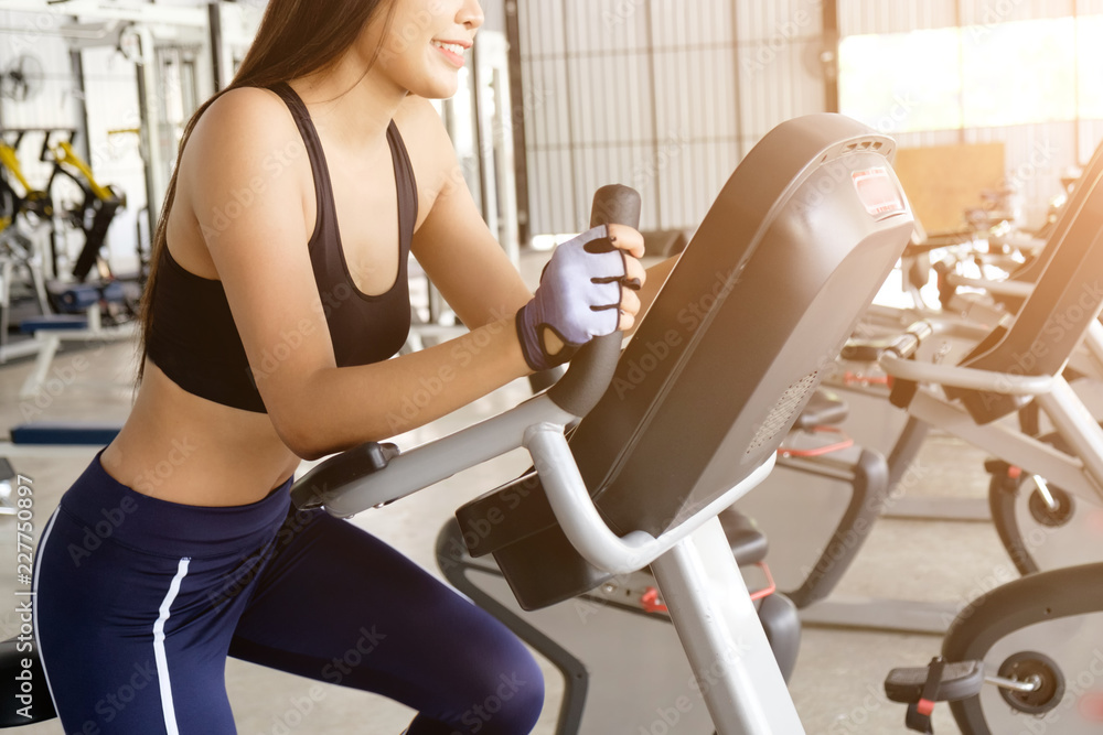 Exercise bike cardio workout at fitness gym taking weight loss with machine aerobic for slim and firm healthy in the morning. Exercise bike cardio workout at fitness gym taking weight loss with machine aerobic for slim and firm healthy in the morning.