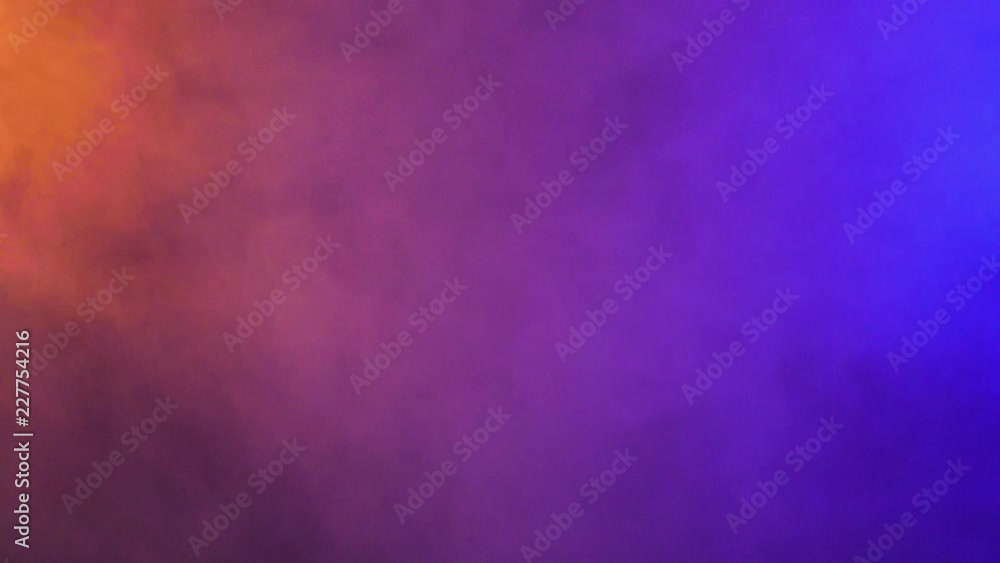 Colorful smoke clouds blurred and abstract over a black background in studio Colorful smoke clouds blurred and abstract over a black background in studio