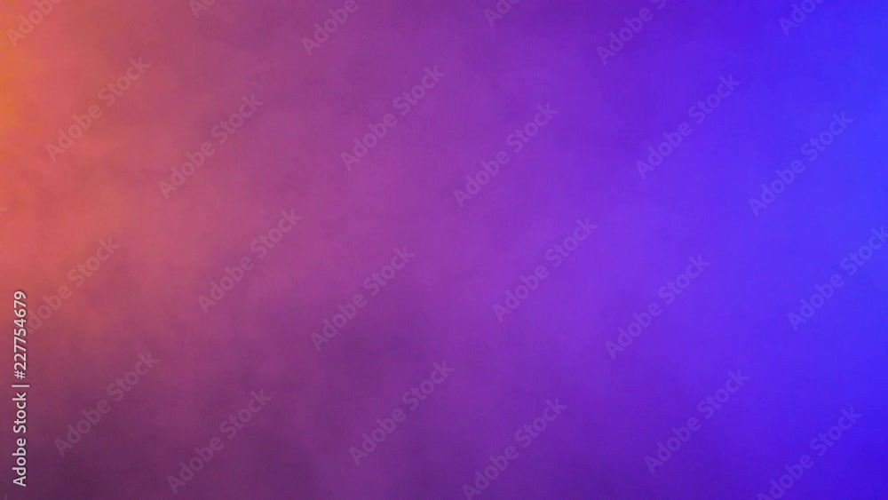 Flowing abstract colorful smoke clouds over a black background in studio Flowing abstract colorful smoke clouds over a black background in studio