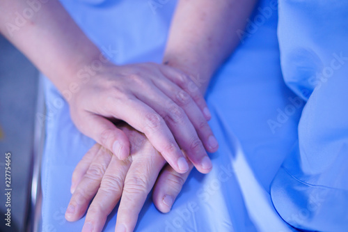 Touching hands Asian senior or elderly old lady woman patient with love  care  helping  encourage and empathy at nursing hospital ward   healthy strong medical concept 