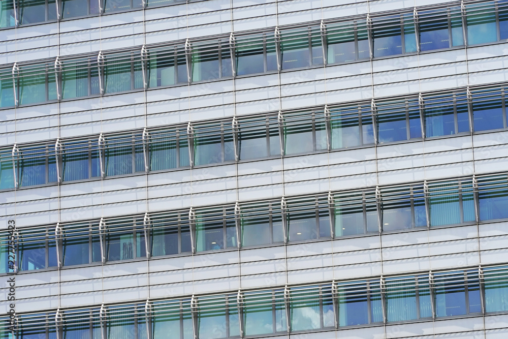 Glass grey square Windows of modern city business building skyscraper. Glass balconies in the building. Modern apartment buildings in new neighborhood. Windows of a building, texture. Glass grey square Windows of modern city business building skyscraper. Glass balconies in the building. Modern apartment buildings in new neighborhood. Windows of a building, texture.