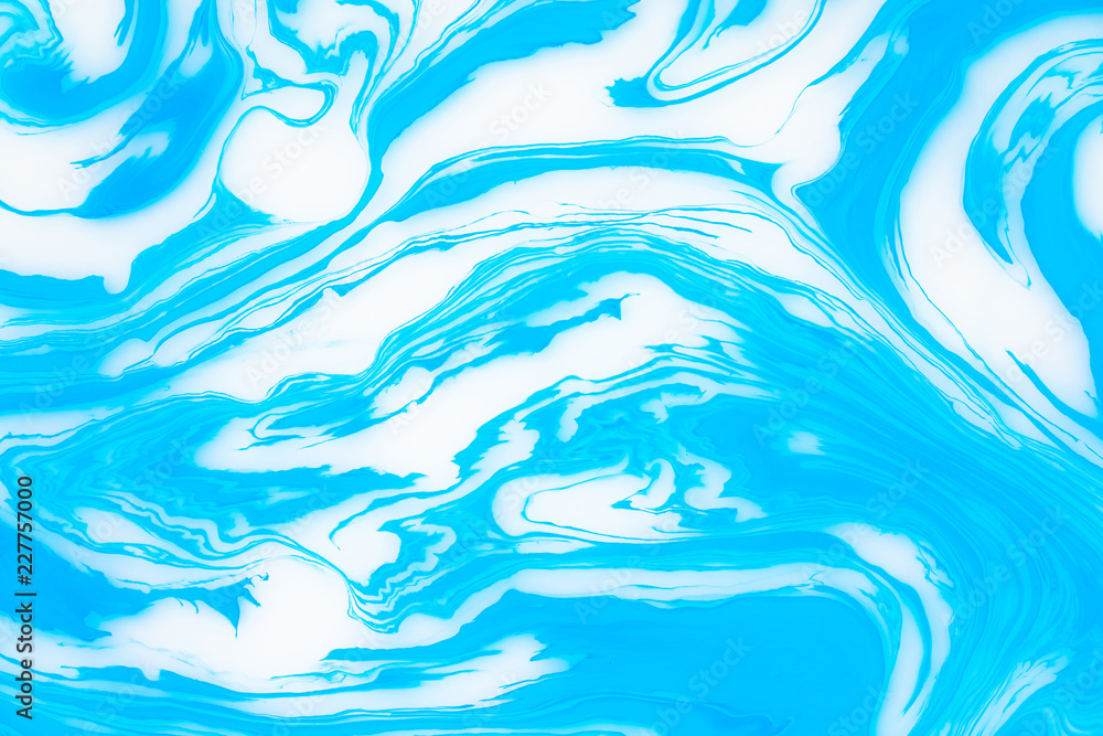 Abstract blue marble background. Stains of paint on the water.