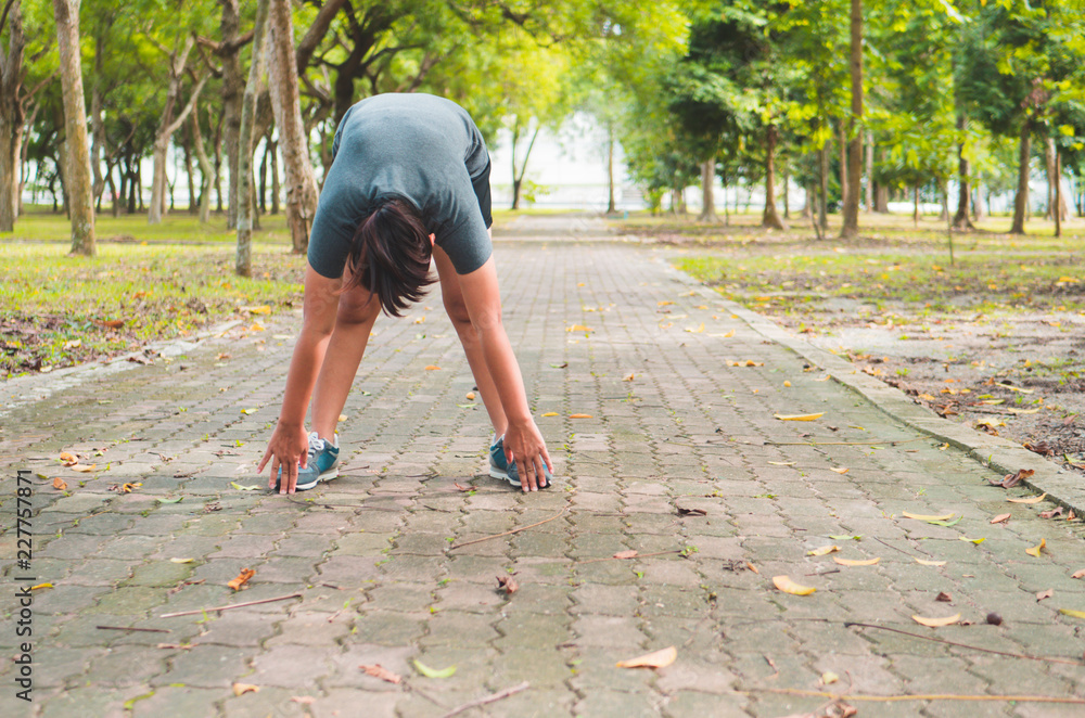 Fototapeta premium fitness woman runner stretching legs before run.