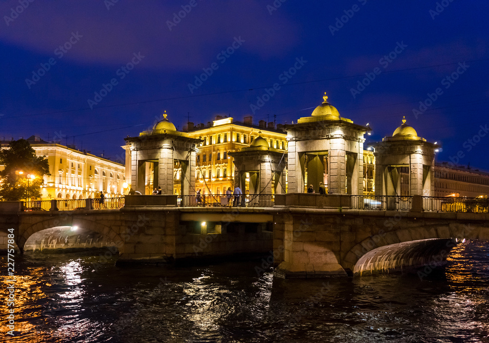 Brightly lit Lomonosov bridge at night in St. Petersburg. Russia