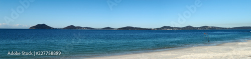 Panorama of a white sand beach and mountains