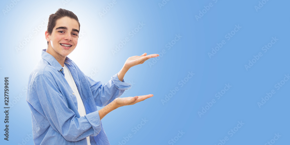 portrait of young with braces isolated in white pointing portrait of young with braces isolated in white pointing