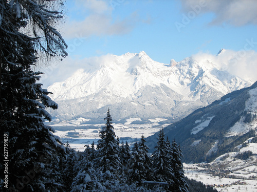 Zellermoos and Krossenbach taken from Kaprun ski resort slopes with snow covered pine trees framing the image and beautiful Alpine scene in the background photo