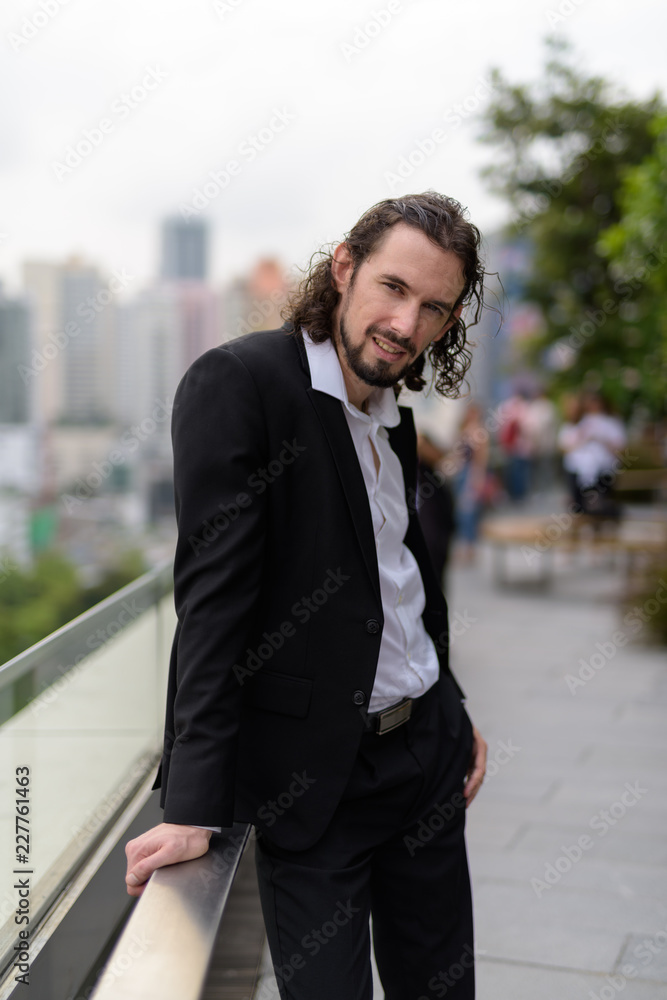 Handsome businessman against view of the city in Bangkok, Thaila Handsome businessman against view of the city in Bangkok, Thaila