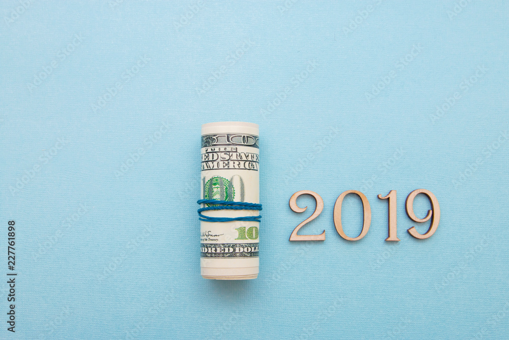 dollar money into the pipe and wooden figures 2019, the new year will be richer dollar money into the pipe and wooden figures 2019, the new year will be richer