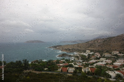 Aegean Coast seen through the rain covered window of a moving vehicle