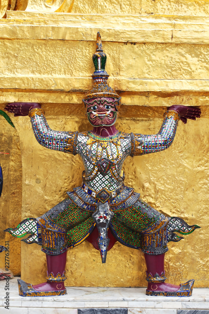 ramayana thai tradition demon statue which support golden chedi