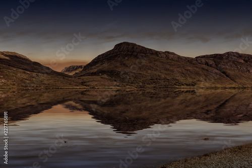Quiet lake in highlands in the sundown