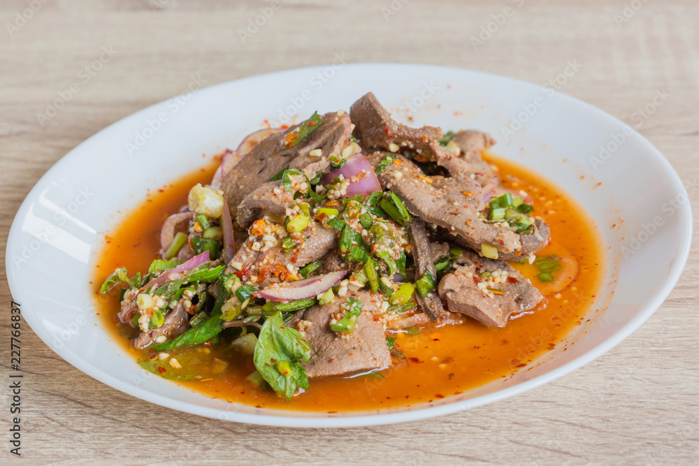 Pork liver spicy salad in white dish, delicious thai food Pork liver spicy salad in white dish, delicious thai food