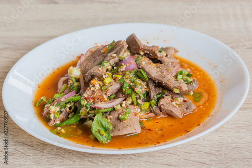 Pork liver spicy salad in white dish, delicious thai food