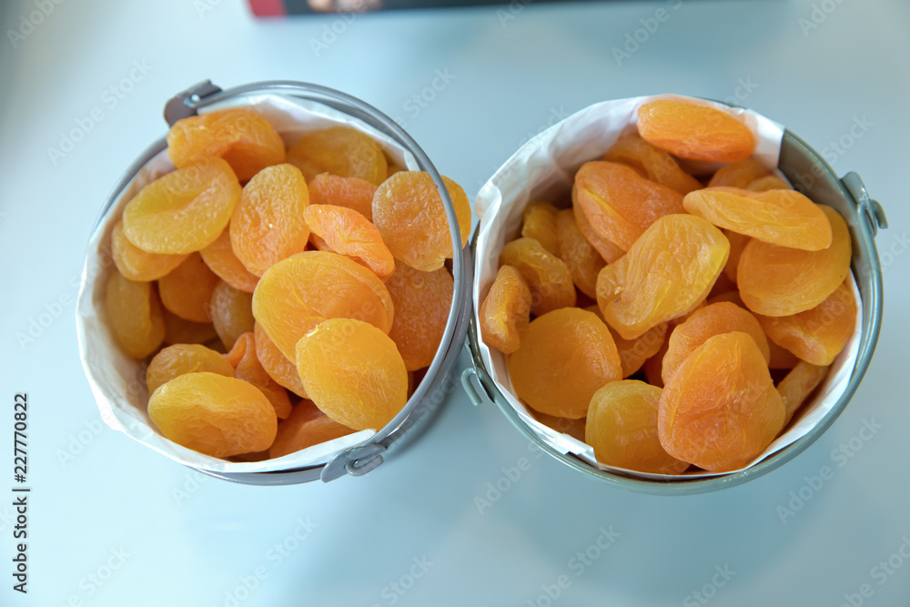 Dried apricots in the bowl . Bowl with dried apricots on white background Dried apricots in the bowl . Bowl with dried apricots on white background