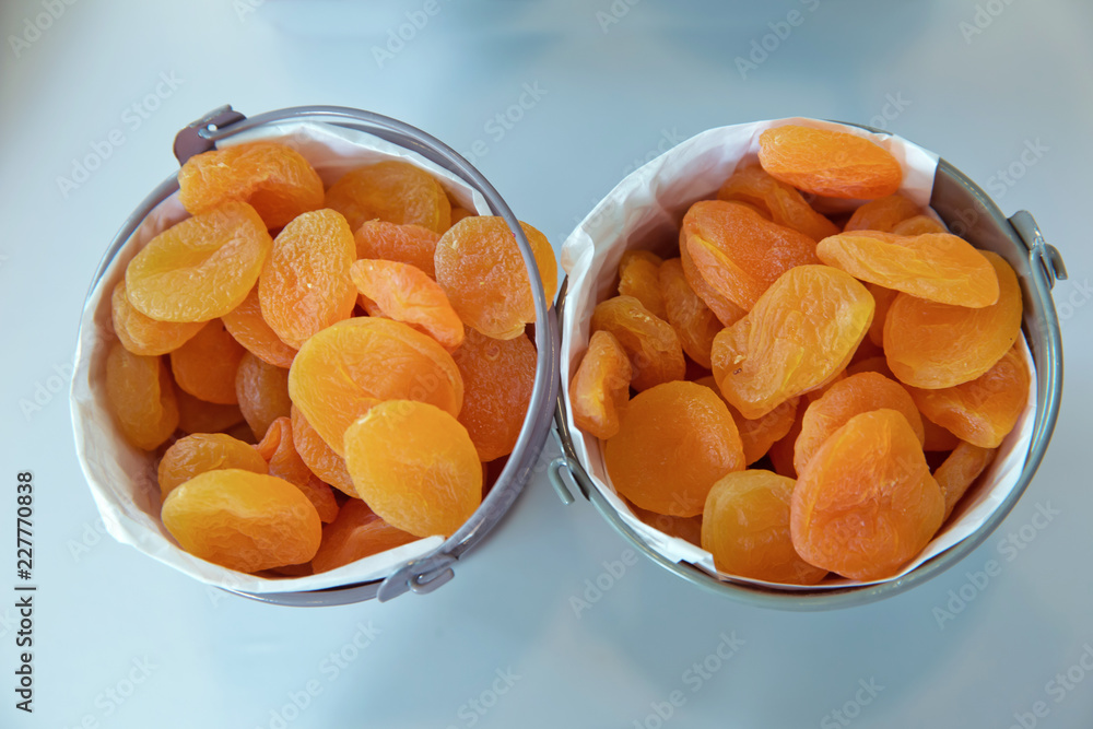 Dried apricots in the bowl . Bowl with dried apricots on white background Dried apricots in the bowl . Bowl with dried apricots on white background