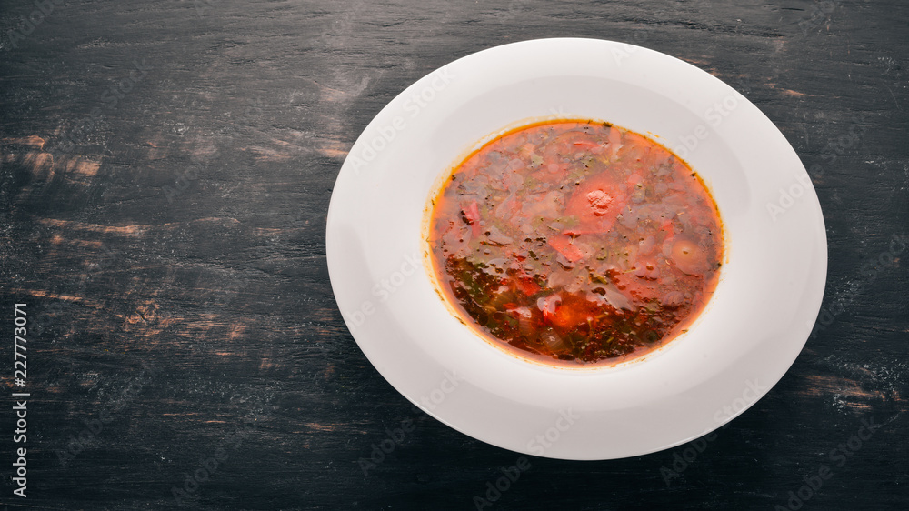 Vegetable soup kharcho. On the old wooden background. Free space for text. Top view. Vegetable soup kharcho. On the old wooden background. Free space for text. Top view.