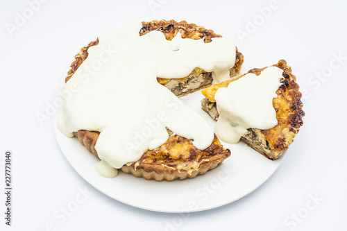Chicken pie with mushrooms, cheese and garlic sauce on white plate photo