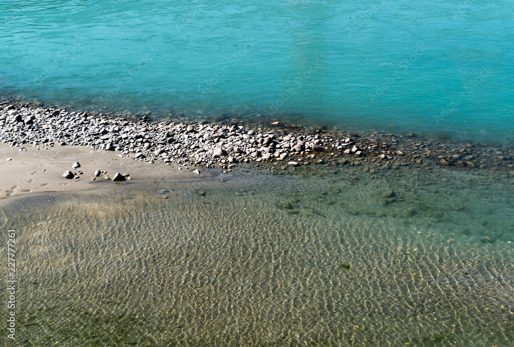 Rhine river with rocks and different color blue water Rhine river with rocks and different color blue water