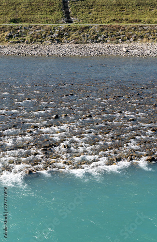 Rhine river with rocks and different color blue water photo